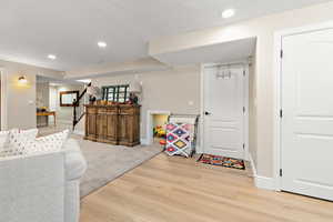Playroom with recessed lighting, baseboards, and wood finished floors