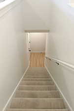 Stairs with baseboards and wood finished floors