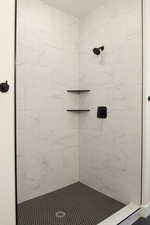 Full bath featuring a tile shower