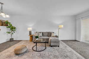 Living room with baseboards and carpet floors