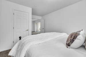 Carpeted bedroom featuring baseboards
