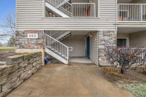Property entrance featuring stone siding