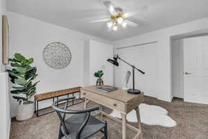 Office featuring a ceiling fan, carpet, and baseboards