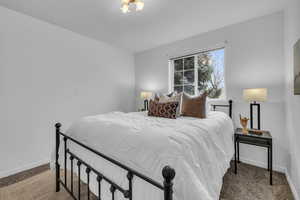 Carpeted bedroom featuring baseboards