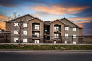 View of front of home featuring a fenced front yard and stucco siding