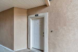 Entrance to property featuring stucco siding