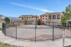 View of front of property featuring a residential view, fence, and a mountain view