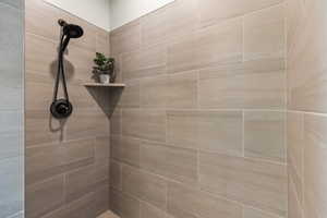 Bathroom featuring tiled shower