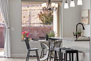 Dining area with a chandelier and baseboards