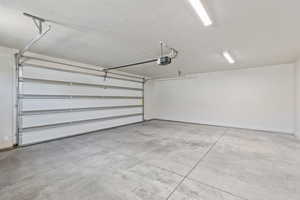 Garage with a garage door opener and baseboards