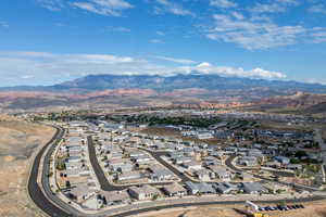 Aerial view of property's location with a mountain backdrop and nearby suburban area