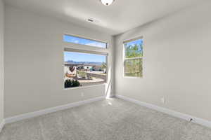 Unfurnished room featuring carpet and baseboards