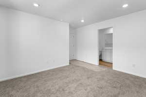 Unfurnished room with light colored carpet, baseboards, and recessed lighting