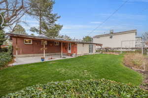 Covered patio with spacious backyard