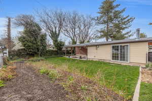 View of yard with a patio and fence