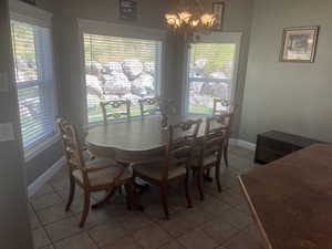Dining space featuring a chandelier and light tile patterned floors