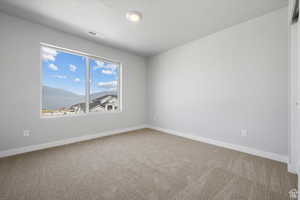 Carpeted empty room featuring baseboards and visible vents