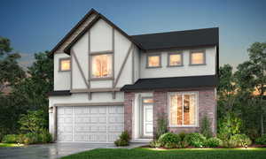 English style home featuring concrete driveway, stucco siding, an attached garage, brick siding, and a shingled roof