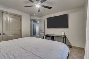 Bedroom with carpet, baseboards, and ceiling fan
