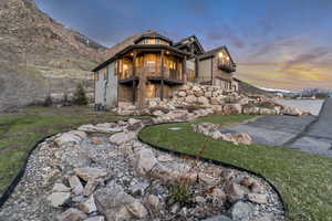 Exterior space featuring a balcony and stone siding