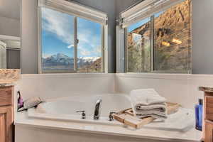 Full bathroom featuring a mountain view, a bath, and vanity
