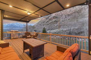Deck with a mountain view, outdoor lounge area, and a grill