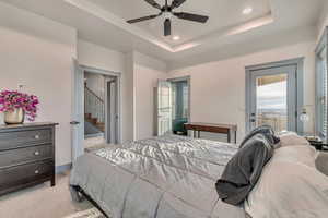 Bedroom featuring access to outside, light carpet, recessed lighting, and a raised ceiling