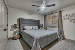 Bedroom with baseboards, carpet flooring, ceiling fan, and visible vents