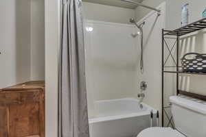 Full bathroom with shower / bath combo and toilet