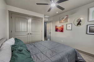 Bedroom with a ceiling fan and a closet