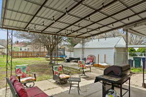 View of patio featuring a trampoline and a fenced backyard