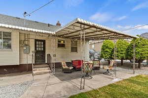 View of patio with a carport and an outdoor hangout area