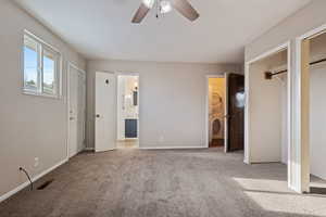 Unfurnished bedroom featuring two closets, carpet floors, baseboards, and visible vents