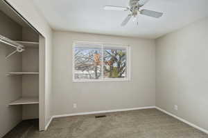 Unfurnished bedroom featuring baseboards, visible vents, a closet, and carpet flooring