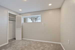 Unfurnished bedroom featuring baseboards, a closet, carpet floors, and recessed lighting