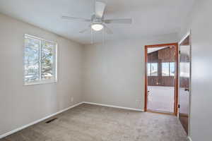 Unfurnished room with baseboards, visible vents, ceiling fan, and carpet floors