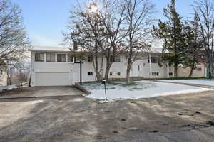 Bi-level home featuring driveway and a garage