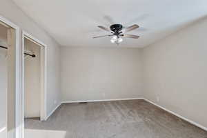 Unfurnished bedroom featuring carpet, baseboards, and ceiling fan