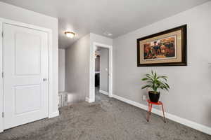 Unfurnished bedroom featuring baseboards, visible vents, and carpet