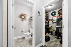 Bathroom with baseboards, visible vents, and toilet
