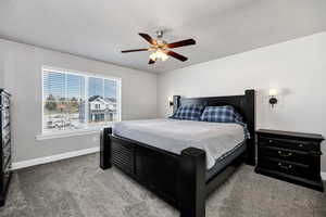 Bedroom featuring baseboards, ceiling fan, and carpet