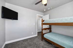 Bedroom featuring baseboards, visible vents, carpet flooring, and a ceiling fan