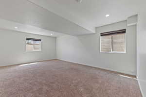 Spare room with baseboards, carpet flooring, and recessed lighting
