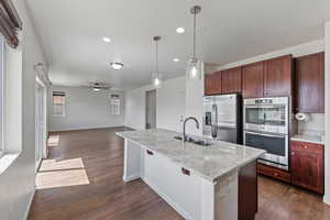 Kitchen with a sink, recessed lighting, a ceiling fan, dark wood finished floors, and appliances with stainless steel finishes