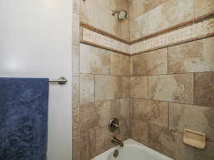 Room details featuring shower / tub combination