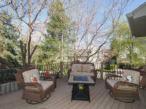 Wooden terrace featuring an outdoor living space with a fire pit