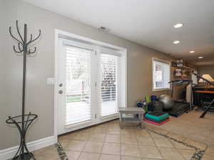 Interior space with light tile patterned floors, recessed lighting, baseboards, and visible vents