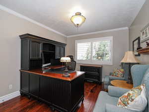 Office with baseboards, a textured ceiling, dark wood-style floors, and crown molding