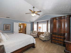 Bedroom with visible vents, ornamental molding, a ceiling fan, light carpet, and lofted ceiling