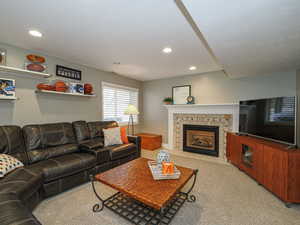 Living area featuring a fireplace, recessed lighting, and carpet